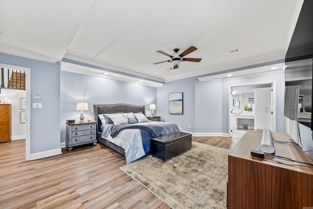 bedroom featuring light hardwood / wood-style floors, ceiling fan, crown molding, and ensuite bathroom