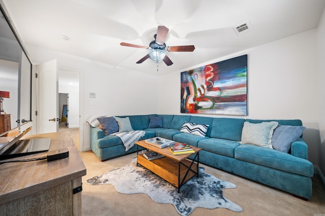 living room featuring light carpet and ceiling fan