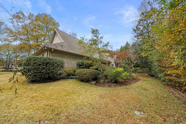 view of side of property featuring a yard