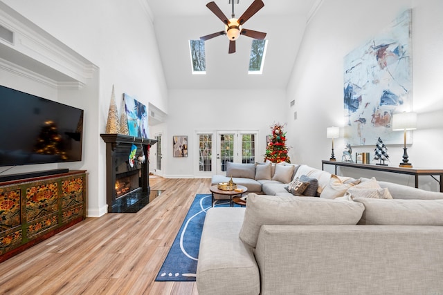 living room featuring ceiling fan, french doors, high vaulted ceiling, crown molding, and hardwood / wood-style flooring