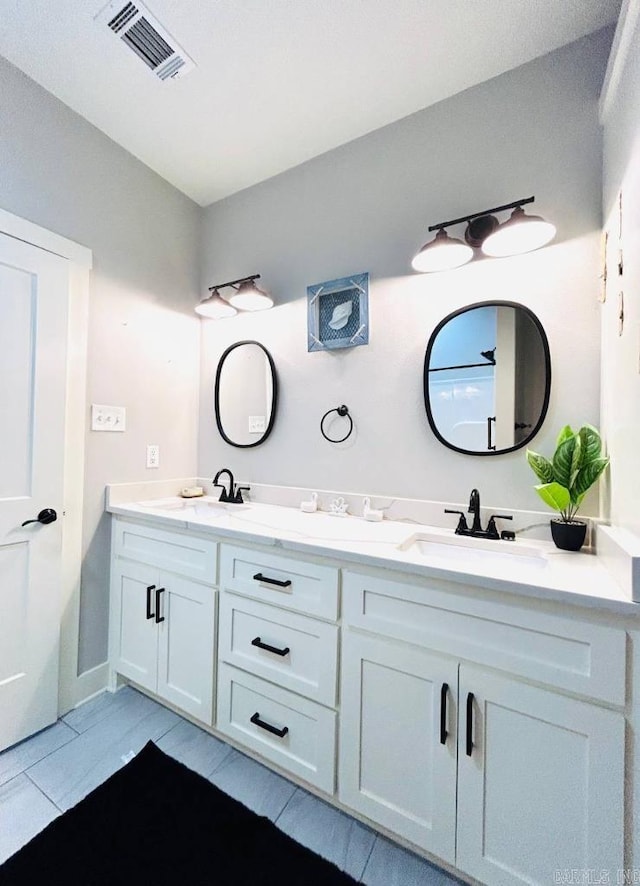 bathroom with tile patterned flooring and vanity