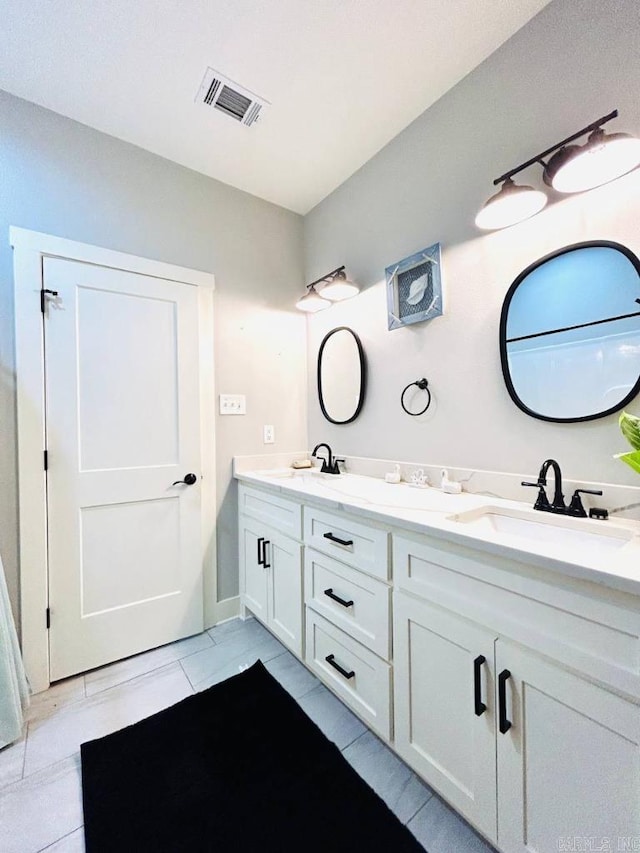 bathroom with tile patterned flooring and vanity