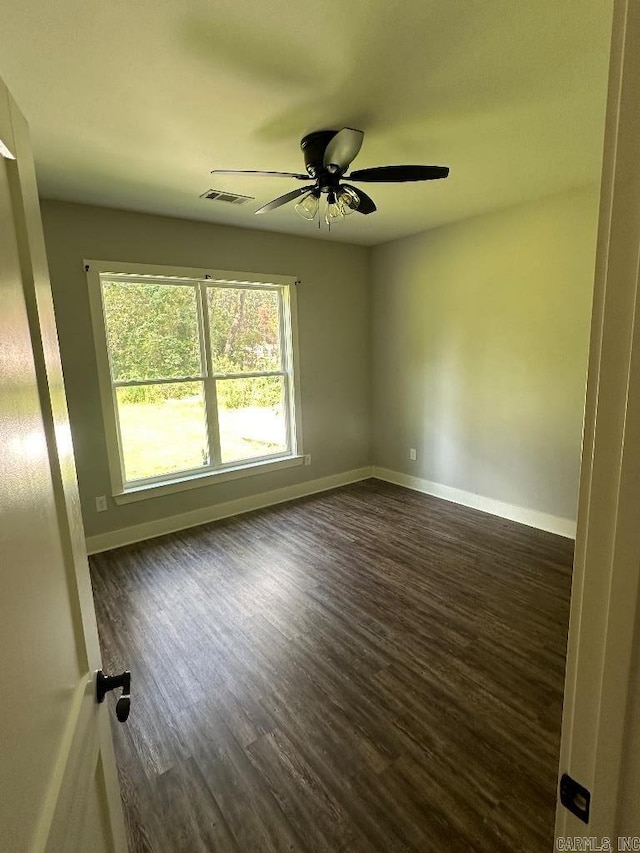 unfurnished room featuring dark hardwood / wood-style flooring and ceiling fan