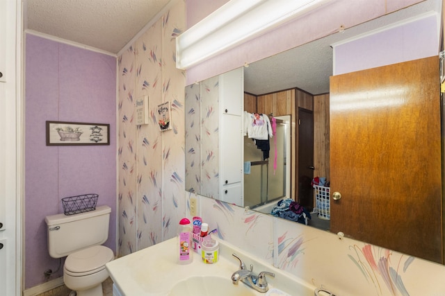 bathroom featuring vanity, a textured ceiling, and toilet