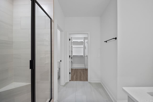 bathroom with vanity, toilet, and walk in shower