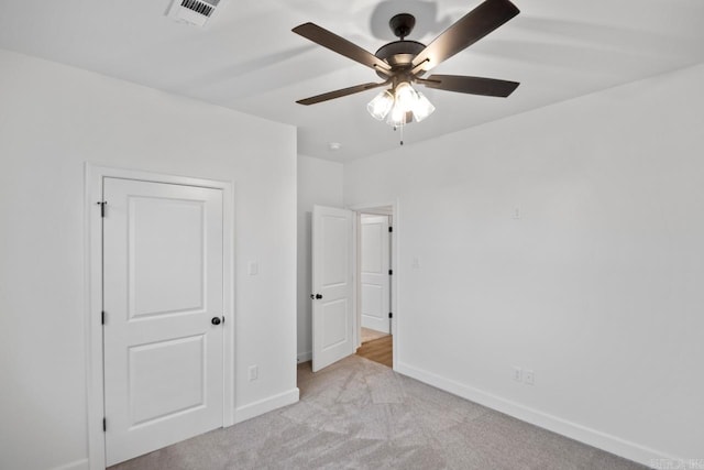 unfurnished bedroom with light carpet and ceiling fan