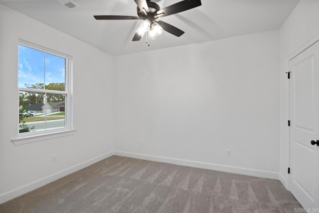 spare room featuring ceiling fan and light carpet