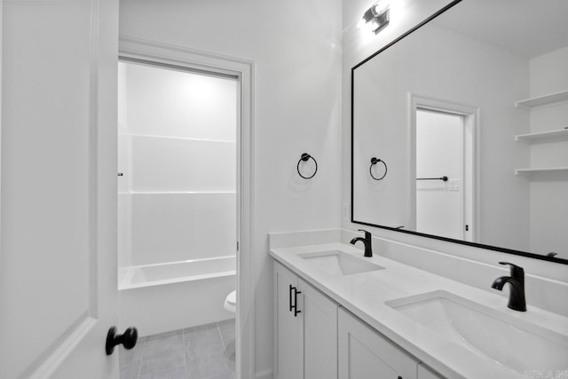 full bathroom with tile patterned floors, vanity, tub / shower combination, and toilet