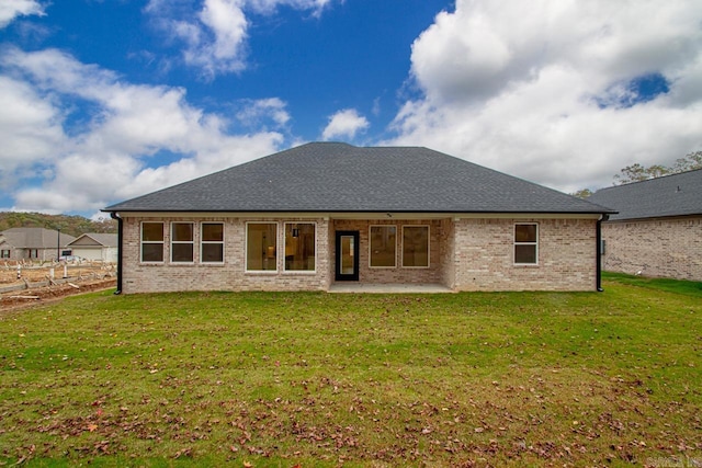 back of house featuring a yard and a patio area