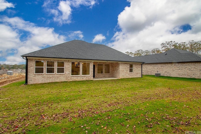 rear view of house with a lawn