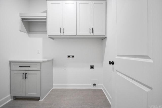 clothes washing area featuring cabinets, washer hookup, and hookup for an electric dryer