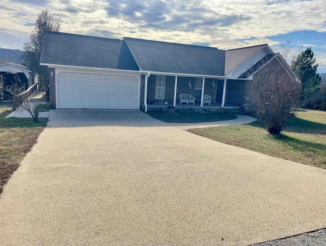 ranch-style house with covered porch and a garage