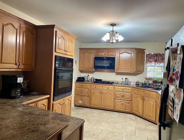 kitchen with sink, a notable chandelier, pendant lighting, light tile patterned floors, and black appliances