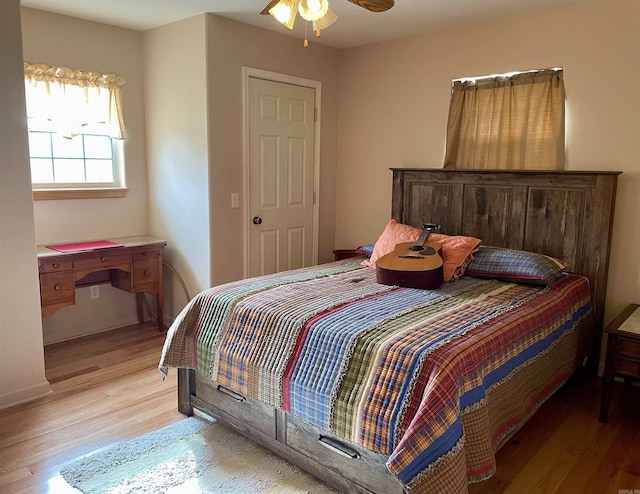 bedroom with light hardwood / wood-style floors and ceiling fan