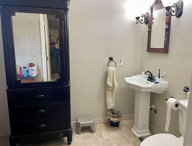 bathroom with tile patterned floors and toilet