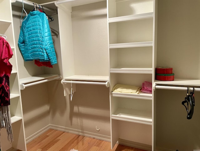 spacious closet with light hardwood / wood-style floors