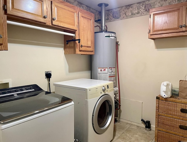 washroom featuring cabinets, light tile patterned floors, and washing machine and clothes dryer