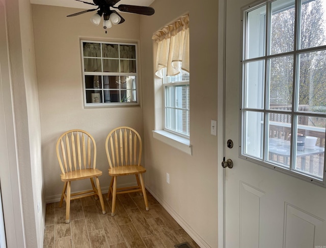 doorway featuring ceiling fan and light hardwood / wood-style flooring