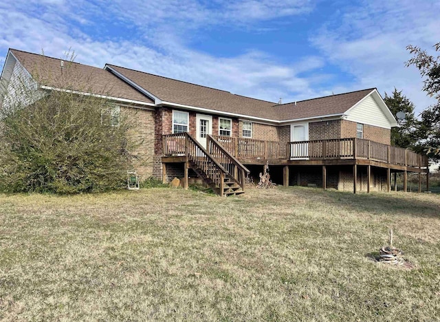 back of house featuring a lawn and a deck