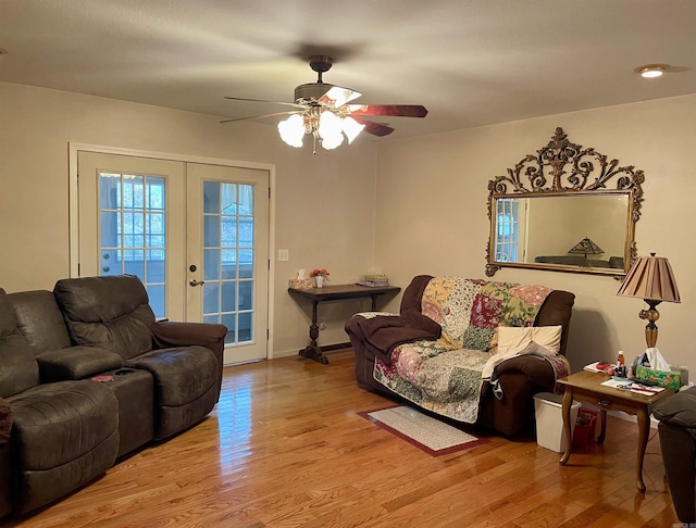 living room with ceiling fan, light wood-type flooring, and french doors