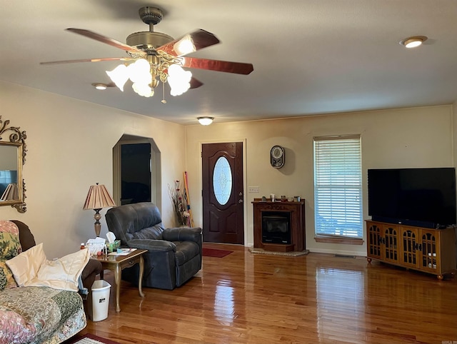 living room with hardwood / wood-style flooring and ceiling fan