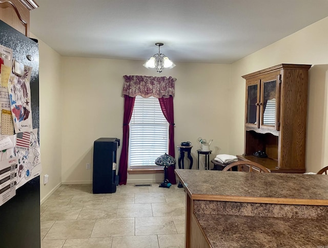 interior space with a chandelier and light tile patterned floors