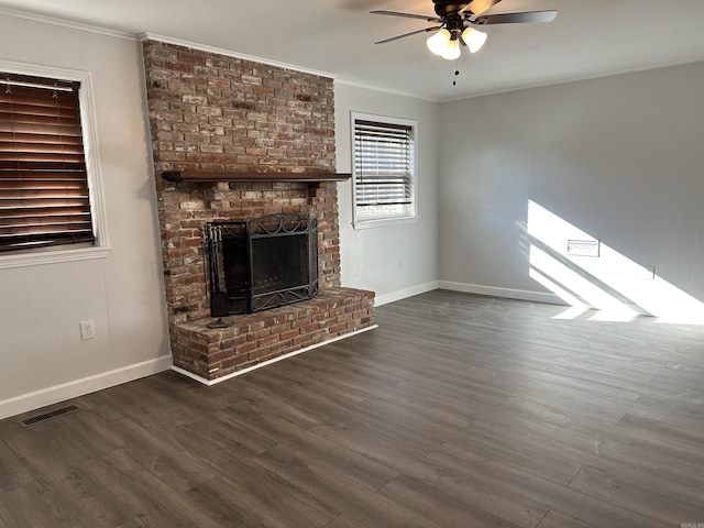 unfurnished living room with dark hardwood / wood-style floors, a fireplace, and crown molding