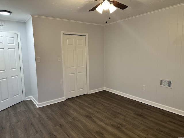 unfurnished bedroom with ceiling fan, dark hardwood / wood-style flooring, and crown molding