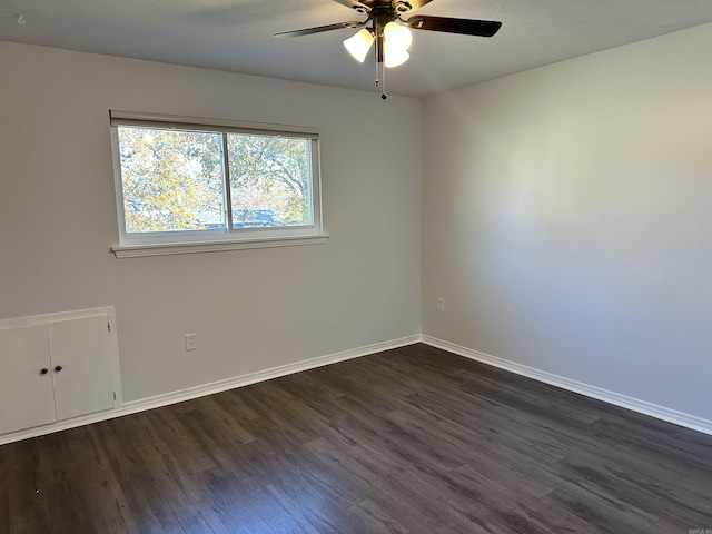 spare room with dark hardwood / wood-style floors and ceiling fan