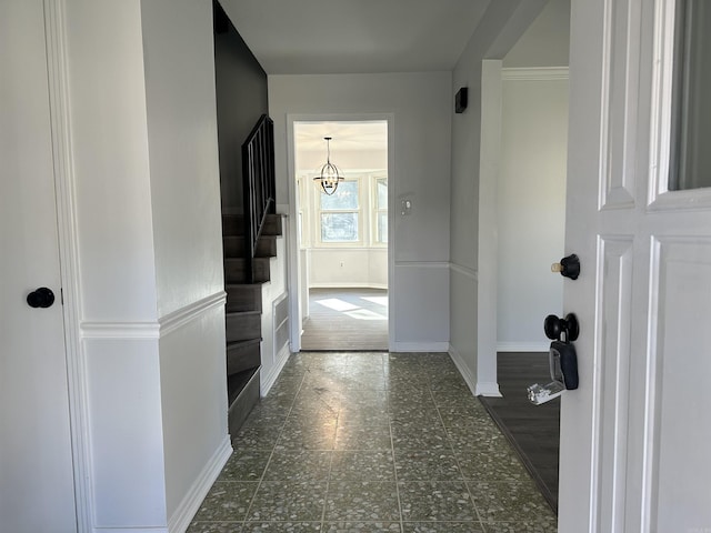 hallway featuring an inviting chandelier