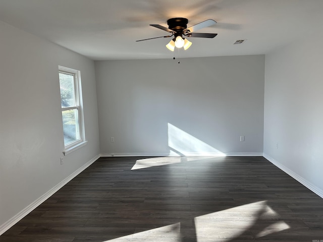 empty room featuring dark hardwood / wood-style flooring and ceiling fan