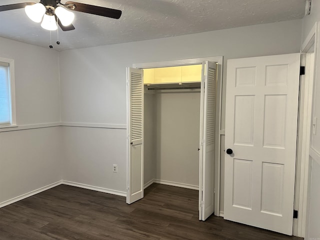 unfurnished bedroom featuring a closet, ceiling fan, and dark wood-type flooring