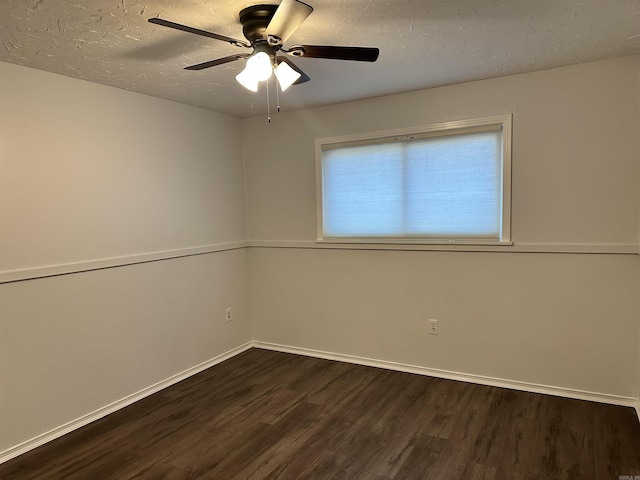 empty room with dark hardwood / wood-style floors, ceiling fan, and a textured ceiling