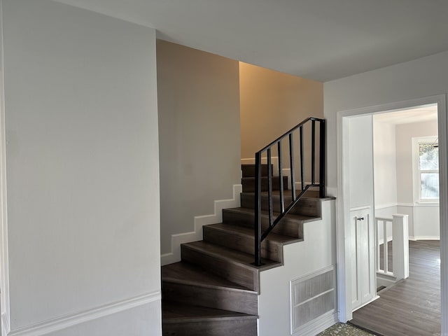 staircase with hardwood / wood-style flooring