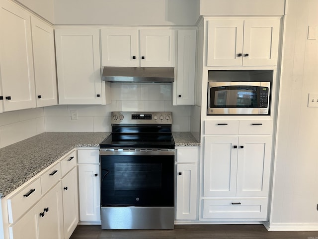 kitchen featuring white cabinets, light stone counters, appliances with stainless steel finishes, and tasteful backsplash