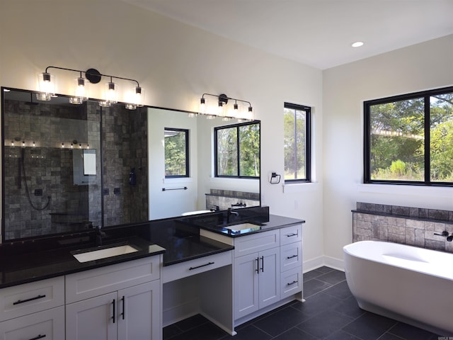 bathroom with tile patterned floors, vanity, and separate shower and tub