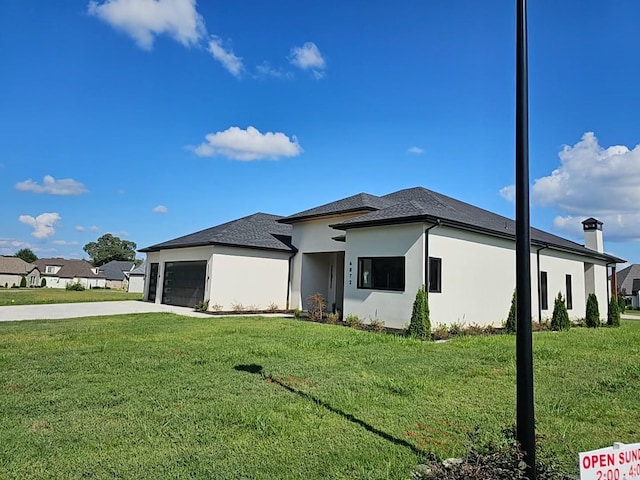 prairie-style house with a garage and a front yard