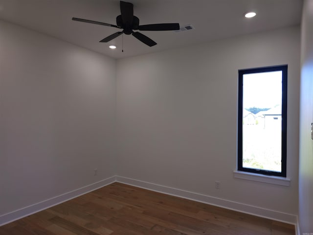 spare room with ceiling fan and dark wood-type flooring