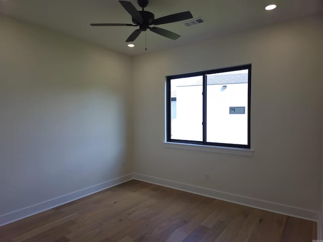 empty room with ceiling fan and dark wood-type flooring