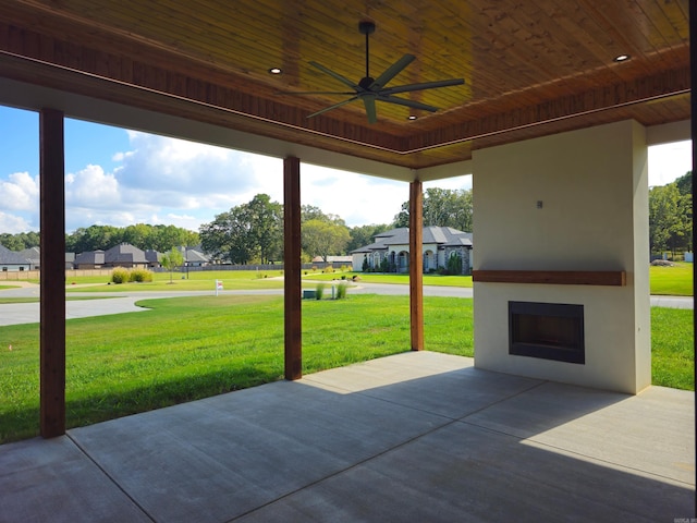 view of patio / terrace with ceiling fan and an outdoor fireplace