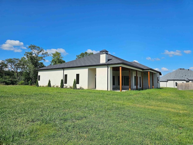 back of house with a yard