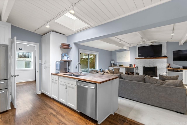 kitchen with dishwasher, butcher block countertops, and track lighting