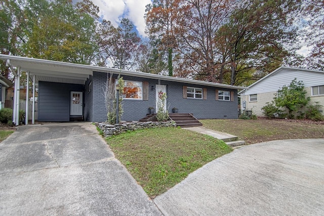 ranch-style home with a carport and a front lawn