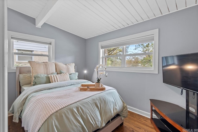 bedroom featuring wood ceiling, vaulted ceiling with beams, and wood-type flooring