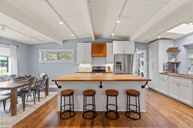 kitchen featuring white cabinetry, wooden counters, and stainless steel appliances