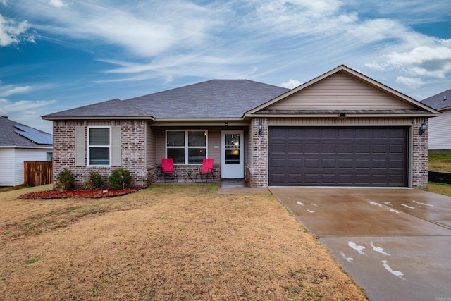 ranch-style home featuring a front yard and a garage