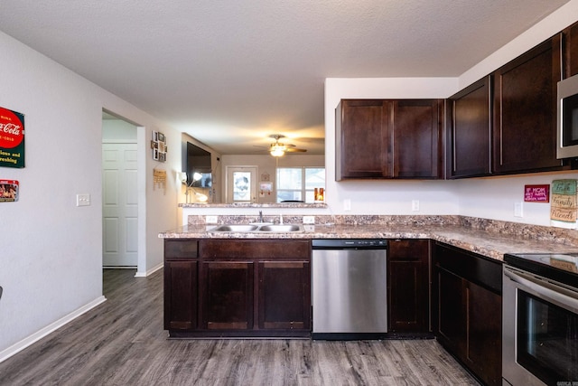 kitchen featuring dark hardwood / wood-style flooring, sink, dark brown cabinetry, and stainless steel appliances