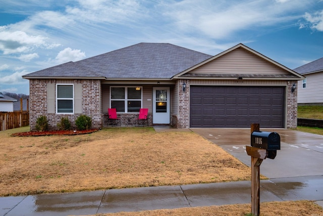 single story home featuring a front yard and a garage