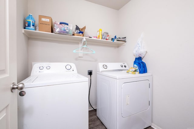 laundry room with independent washer and dryer and dark wood-type flooring