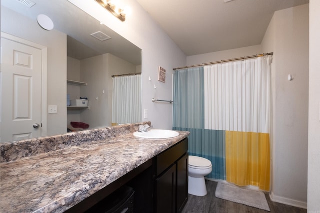 bathroom with hardwood / wood-style flooring, vanity, toilet, and a shower with curtain